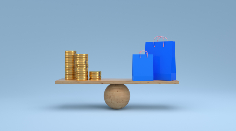 a stack of coins and shopping bags sit on opposite ends of a wooden scale, balancing each other perfectly