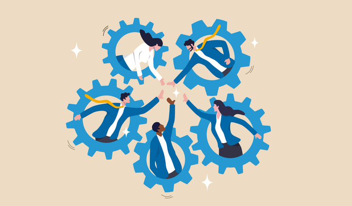 People in a circle each put a hand toward the center, with each person surrounded by a gear.